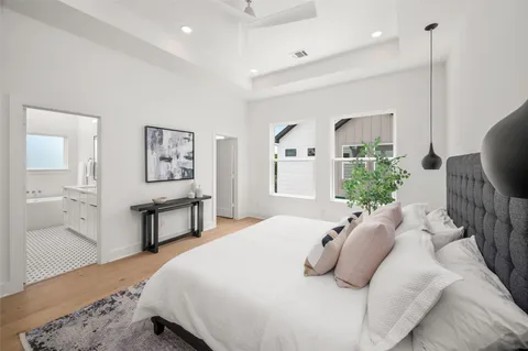 a bedroom with a bed window and potted plant