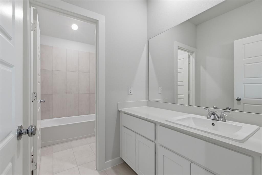 637 Sierra Ridge Lavon, TX 75166 - Photo 17 of 26 a bathroom with a shower sink vanity and mirror