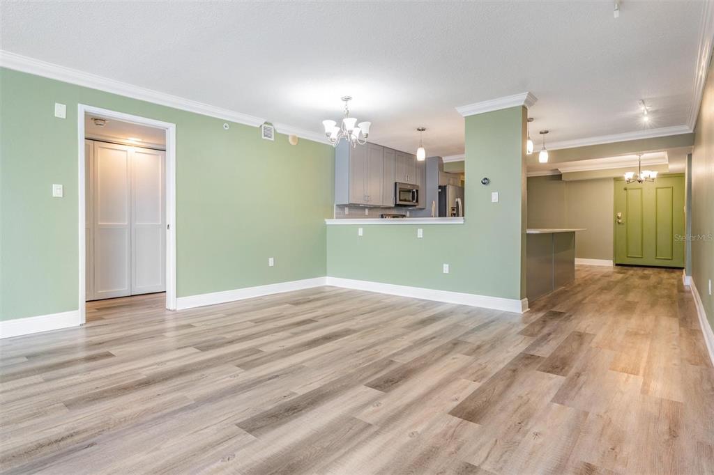 2413 Bayshore Boulevard, Unit 1004 Tampa, FL 33629 - Photo 12 of 36 a view of a room with wooden floor and a kitchen