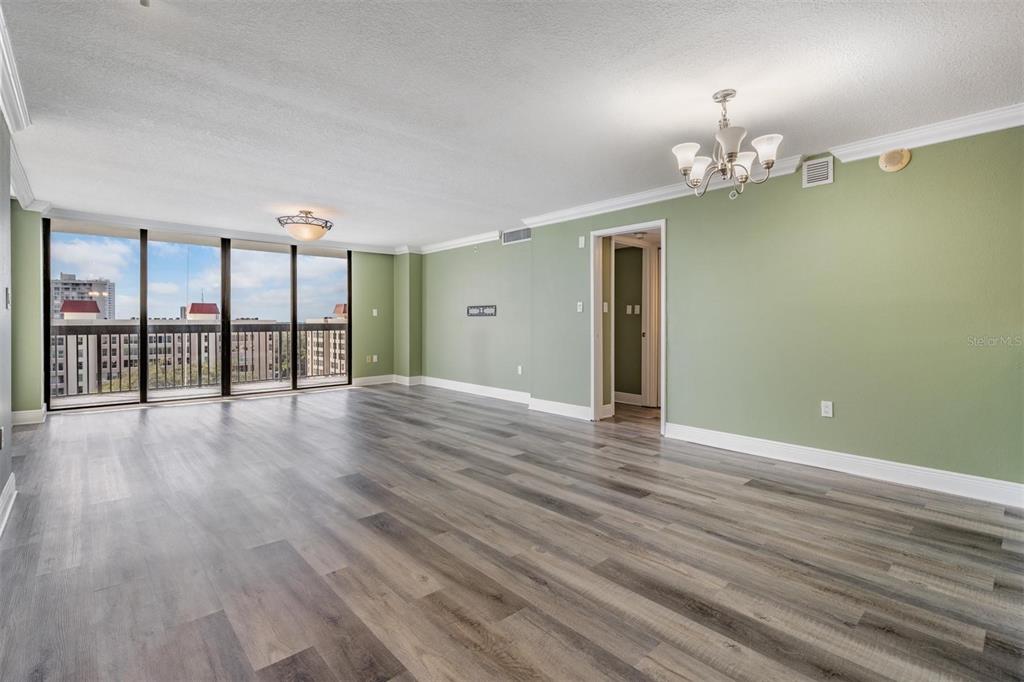 2413 Bayshore Boulevard, Unit 1004 Tampa, FL 33629 - Photo 14 of 36 wooden floor with chandelier and window in a room