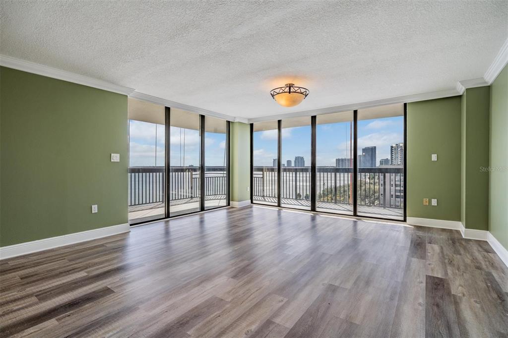 2413 Bayshore Boulevard, Unit 1004 Tampa, FL 33629 - Photo 17 of 36 an empty room with wooden floor and windows