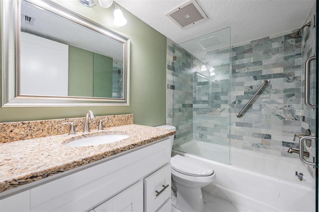 2413 Bayshore Boulevard, Unit 1004 Tampa, FL 33629 - Photo 30 of 36 a bathroom with a granite countertop sink toilet and shower