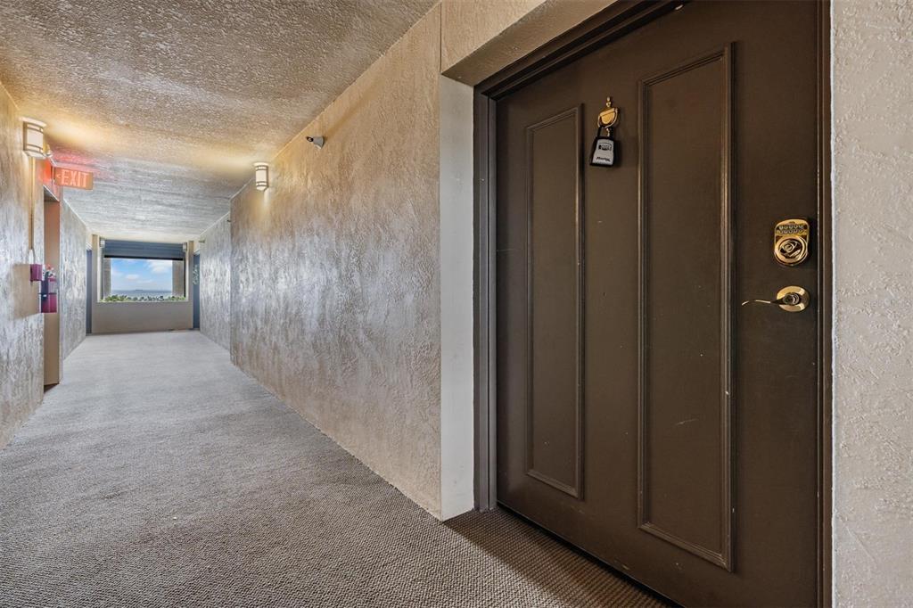 2413 Bayshore Boulevard, Unit 1004 Tampa, FL 33629 - Photo 3 of 36 a view of a hallway with wooden shelves