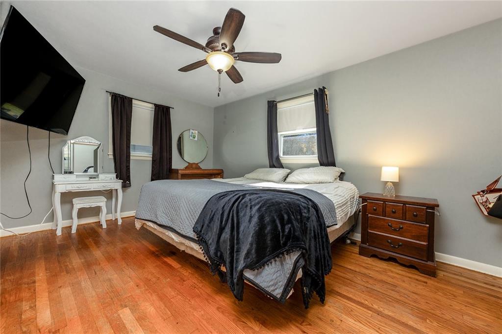 10 Fredonia Road Greenville, PA 16125 - Photo 21 of 28 a bedroom with a bed a flat screen tv and couches