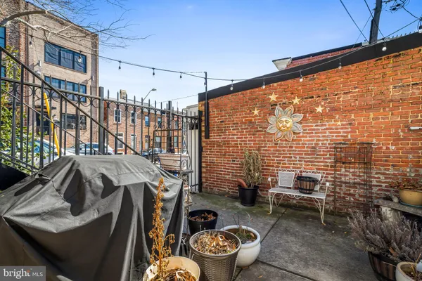 a view of a patio with couches and potted plants