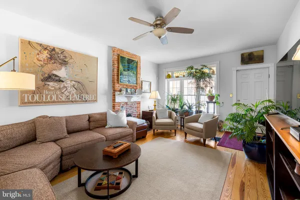 a living room with furniture and a large window with garden view