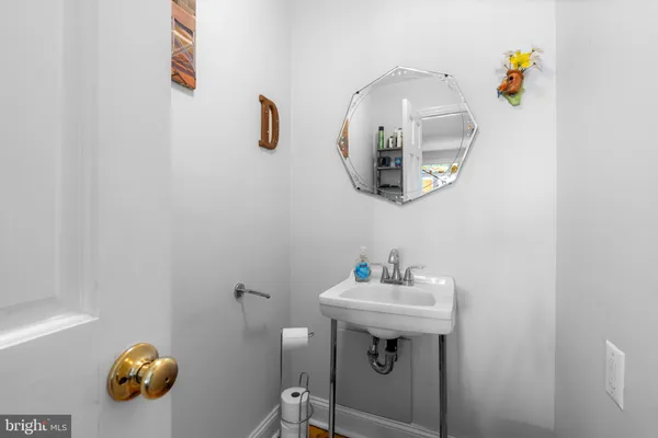 a bathroom with a sink a mirror and vanity