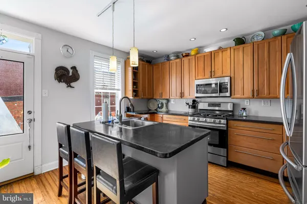 a kitchen with a stove a sink and a microwave