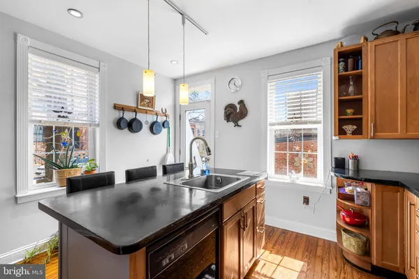 a kitchen with stainless steel appliances granite countertop a sink a stove and a refrigerator