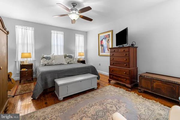 a bedroom with a bed closet and flat tv screen