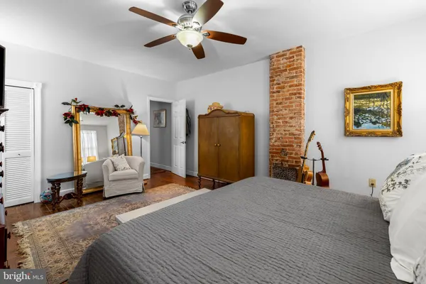 a bedroom with a bed couch and a window