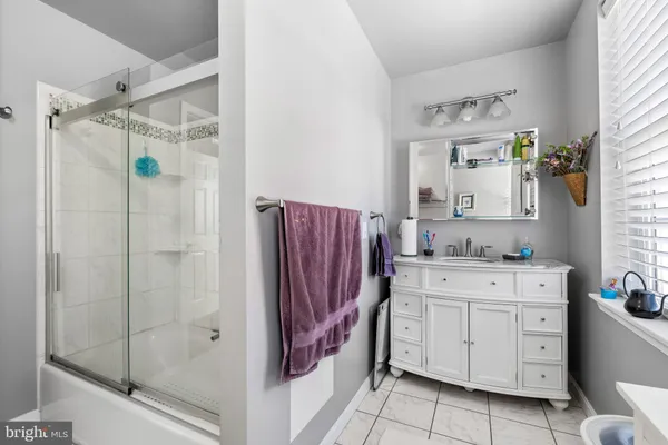 a bathroom with a granite countertop sink a vanity and a mirror