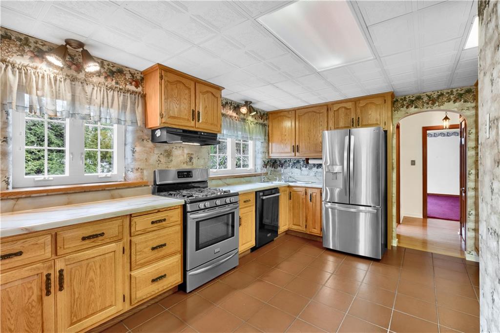 117 Weckerly Road Butler, PA 16002 - Photo 13 of 25 a kitchen with stainless steel appliances granite countertop a refrigerator a stove and a sink with cabinets