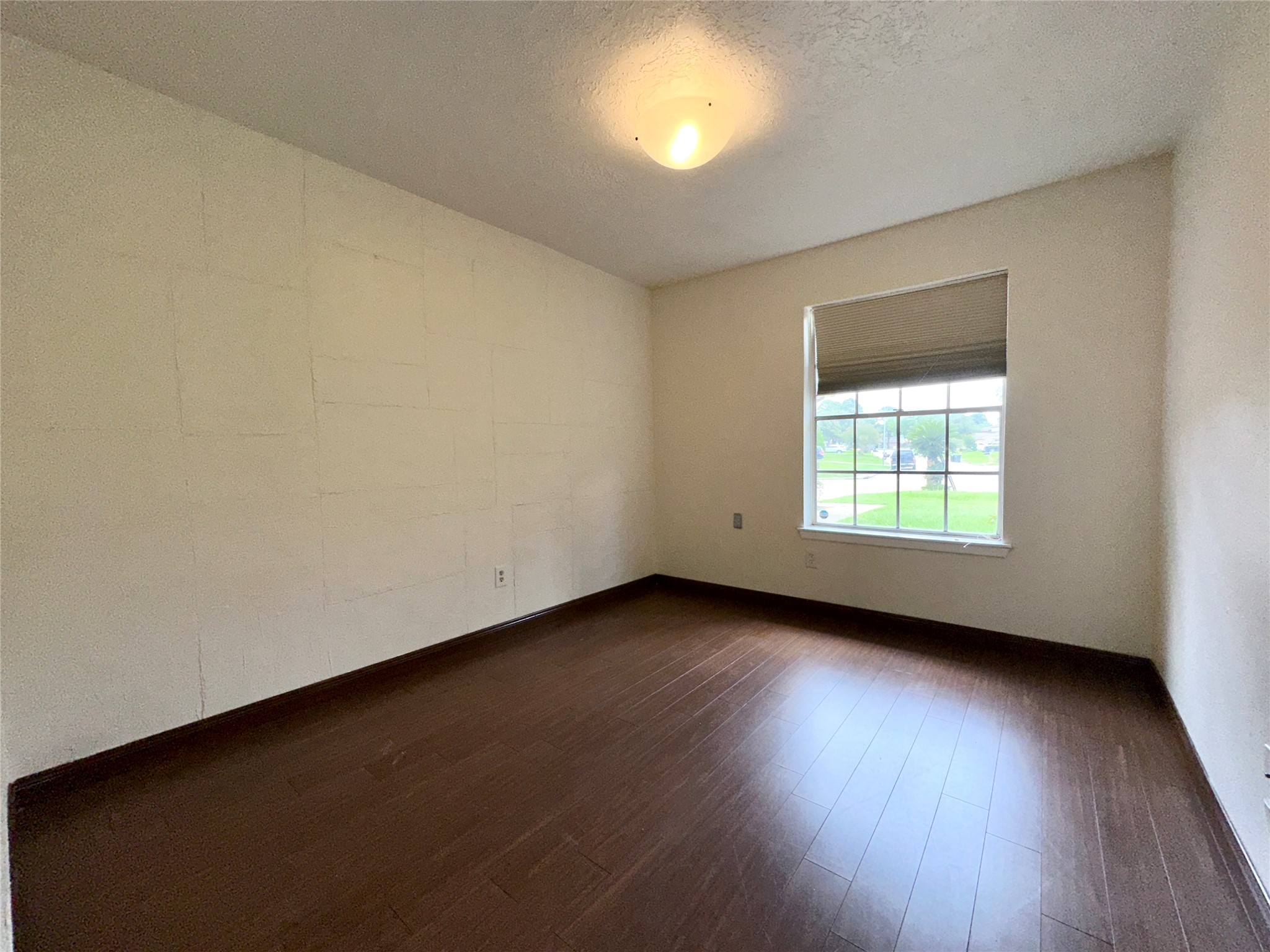 8511 Little River Road Houston, TX 77064 - Photo 16 of 19 an empty room with wooden floor and windows
