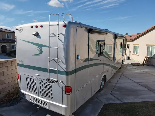 a white bath tub sitting next to a white door and a window
