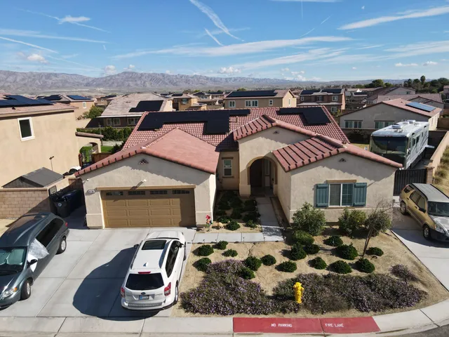 an aerial view of a residential houses with outdoor space