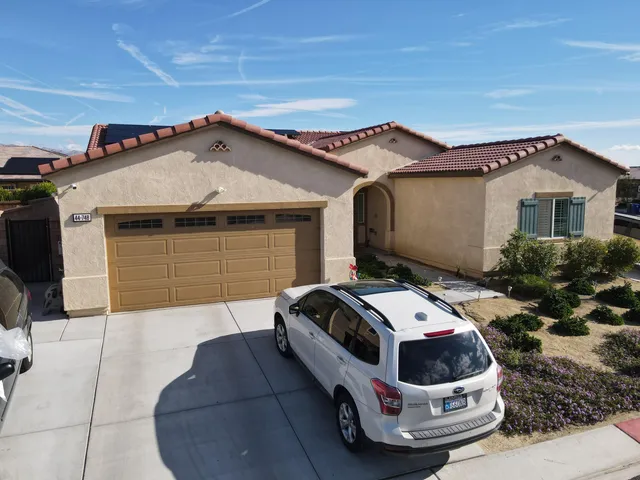a view of a patio with couches table and chairs and potted plants