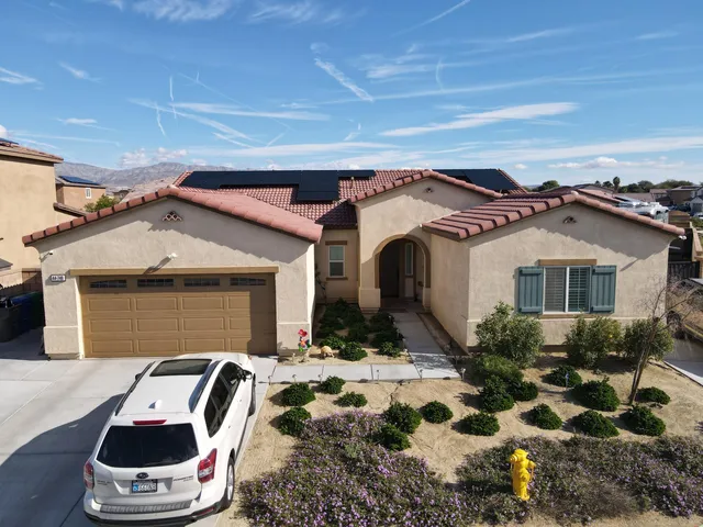 a bedroom with a bed and a ceiling fan