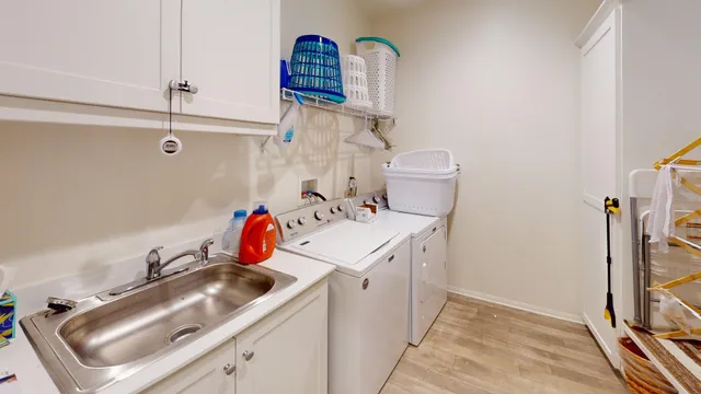 a kitchen that has a lot of cabinets a sink and appliances in it