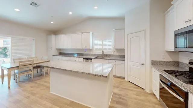 a living room with furniture and a ceiling fan