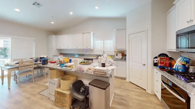 a living room with furniture and a ceiling fan