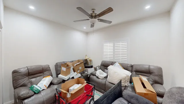 a living room with furniture and a floor to ceiling window