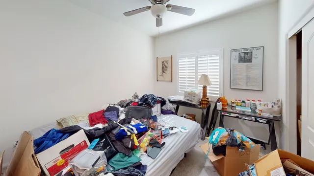 a bed with a bed and a painting on the wall