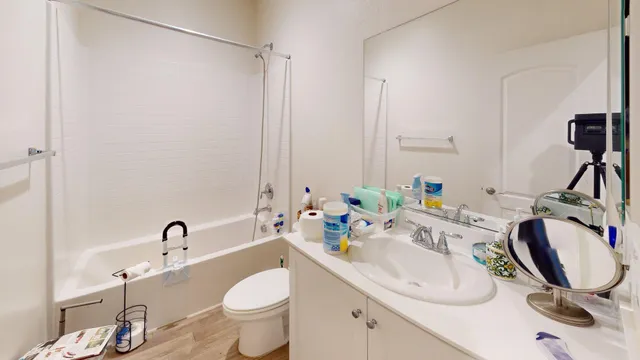 a bathroom with a sink mirror and vanity