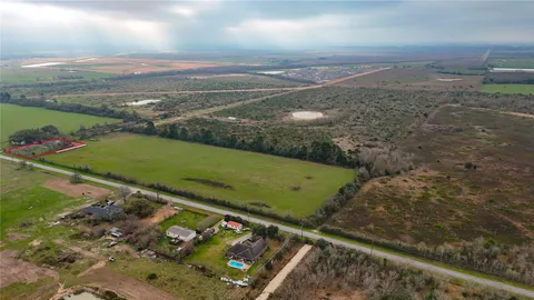 an aerial view of a houses with a yard