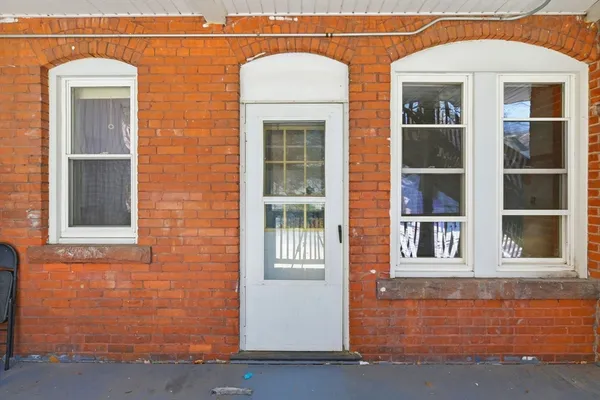 a front view of a house with a large window
