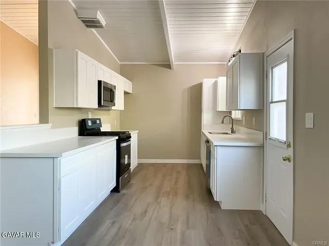 a kitchen with a sink and a refrigerator