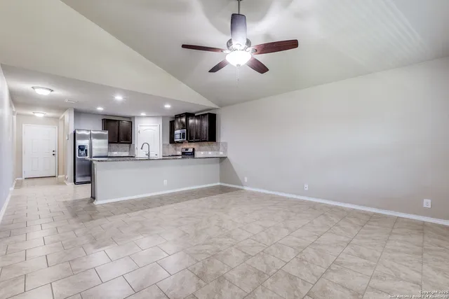 a view of kitchen with refrigerator and window