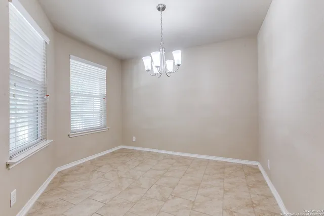 a view of a chandelier in a room and a window