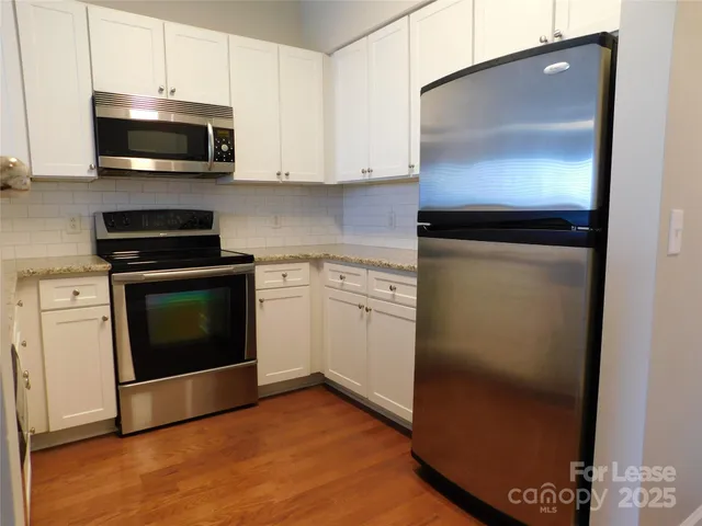 a kitchen with a stove and a microwave