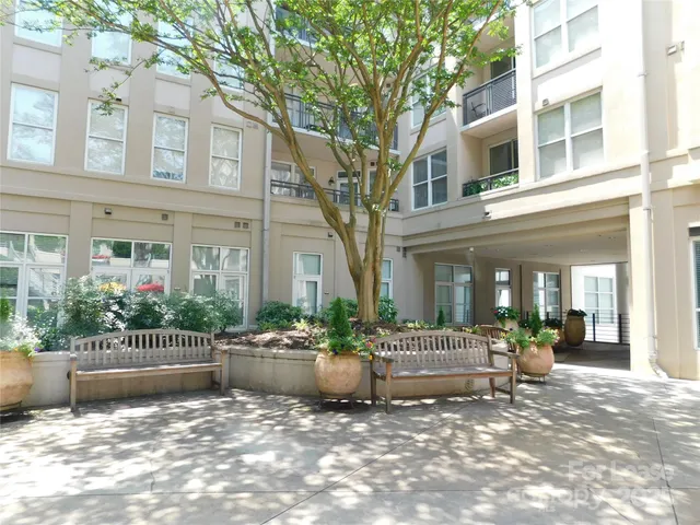 a view of a house with sitting area and swimming pool