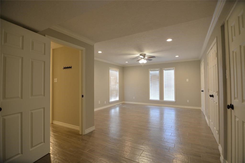 19118 Challe Circle West Spring, TX 77373 - Photo 11 of 21 a view of an empty room with wooden floor and a window