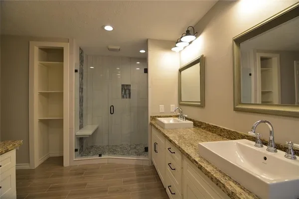 a bathroom with double sink and shower