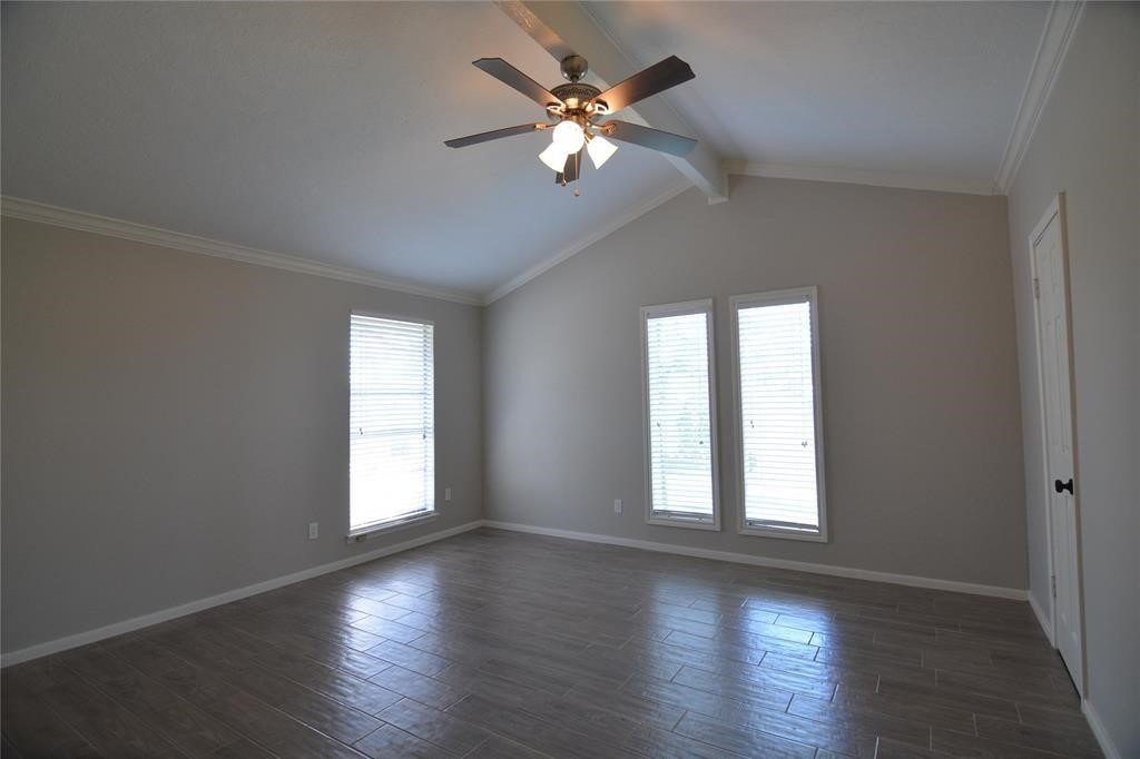 19118 Challe Circle West Spring, TX 77373 - Photo 17 of 21 an empty room with wooden floor chandelier fan and windows