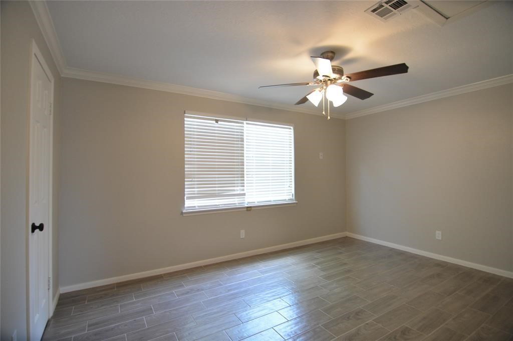 19118 Challe Circle West Spring, TX 77373 - Photo 18 of 21 an empty room with wooden floor fan and windows