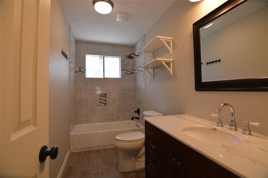 19118 Challe Circle West Spring, TX 77373 - Photo 19 of 21 a bathroom with a granite countertop sink toilet and shower