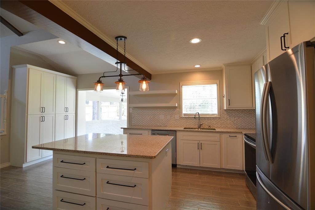 19118 Challe Circle West Spring, TX 77373 - Photo 6 of 21 a kitchen with stainless steel appliances granite countertop a sink stove and refrigerator