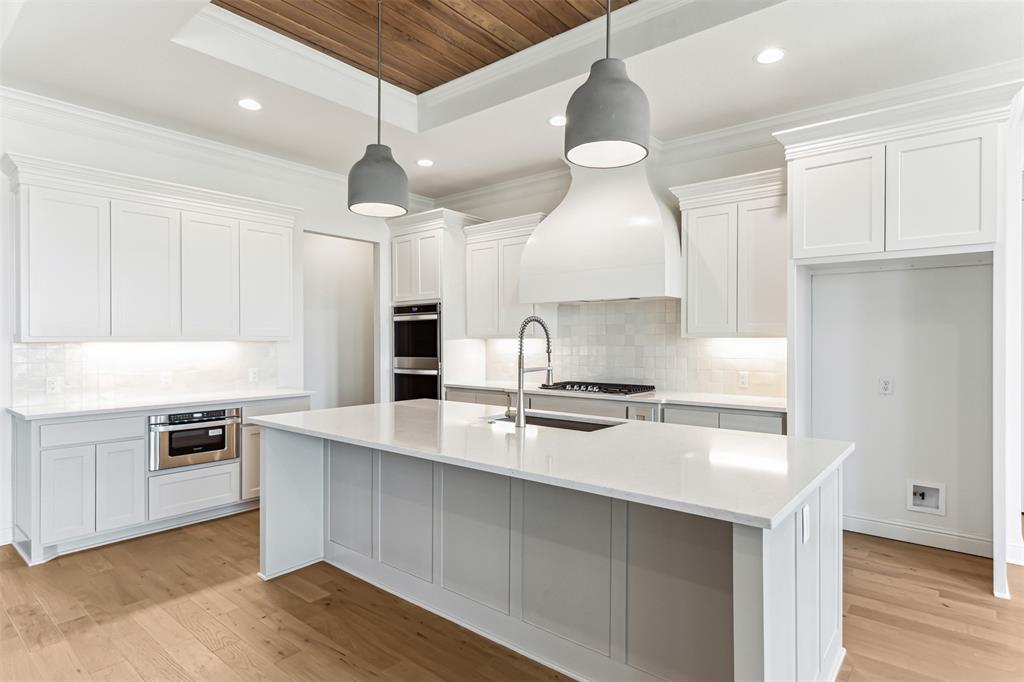 151 Ava Rose Lane Waxahachie, TX 75167 - Photo 13 of 32 a kitchen with a stove a sink and a refrigerator
