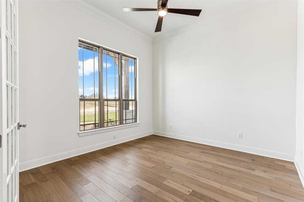 151 Ava Rose Lane Waxahachie, TX 75167 - Photo 17 of 32 an empty room with wooden floor fan and windows