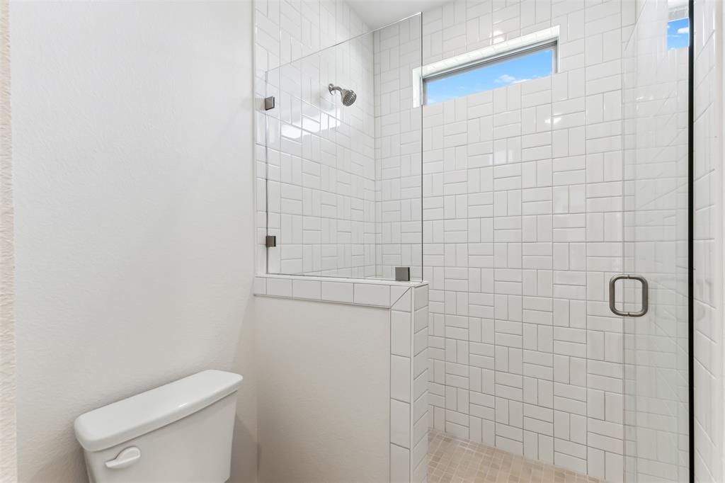 151 Ava Rose Lane Waxahachie, TX 75167 - Photo 25 of 32 a bathroom with a toilet and shower