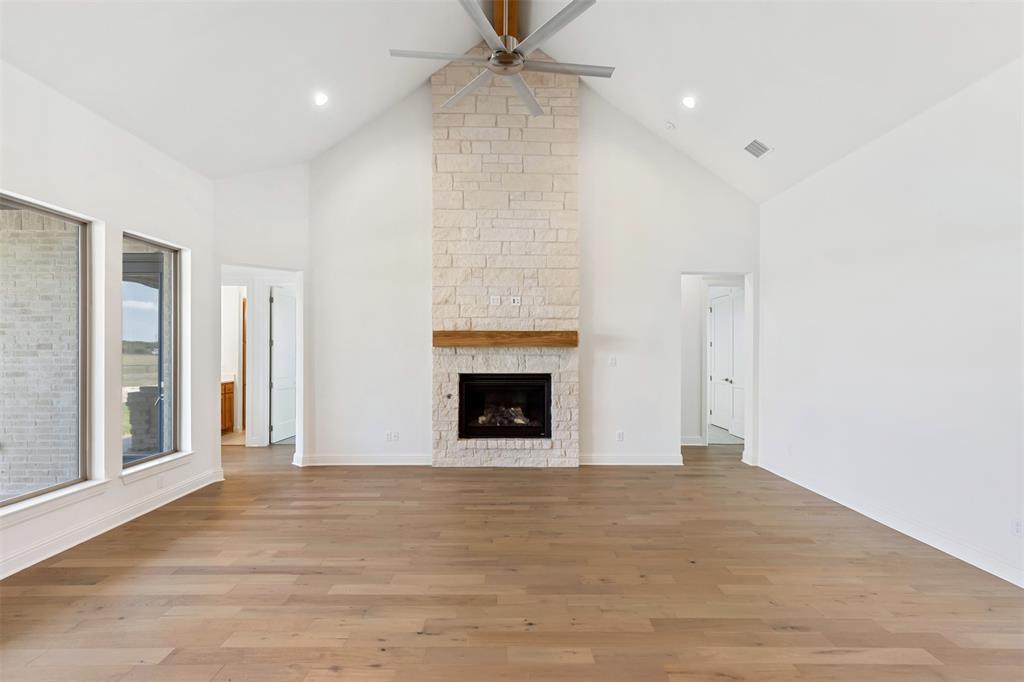 151 Ava Rose Lane Waxahachie, TX 75167 - Photo 8 of 32 a view of a room with an empty space and a fireplace