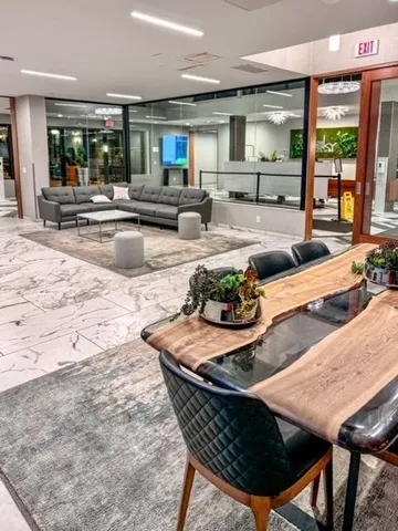 a living room with furniture and large windows