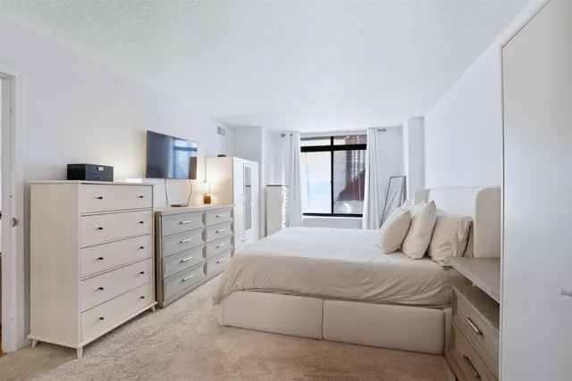 a bedroom with a bed and a dresser