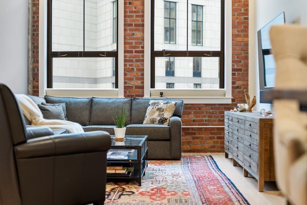 121 Portland Street, Unit 206 Boston, MA 02114 - Photo 11 of 35 a living room with furniture and a window
