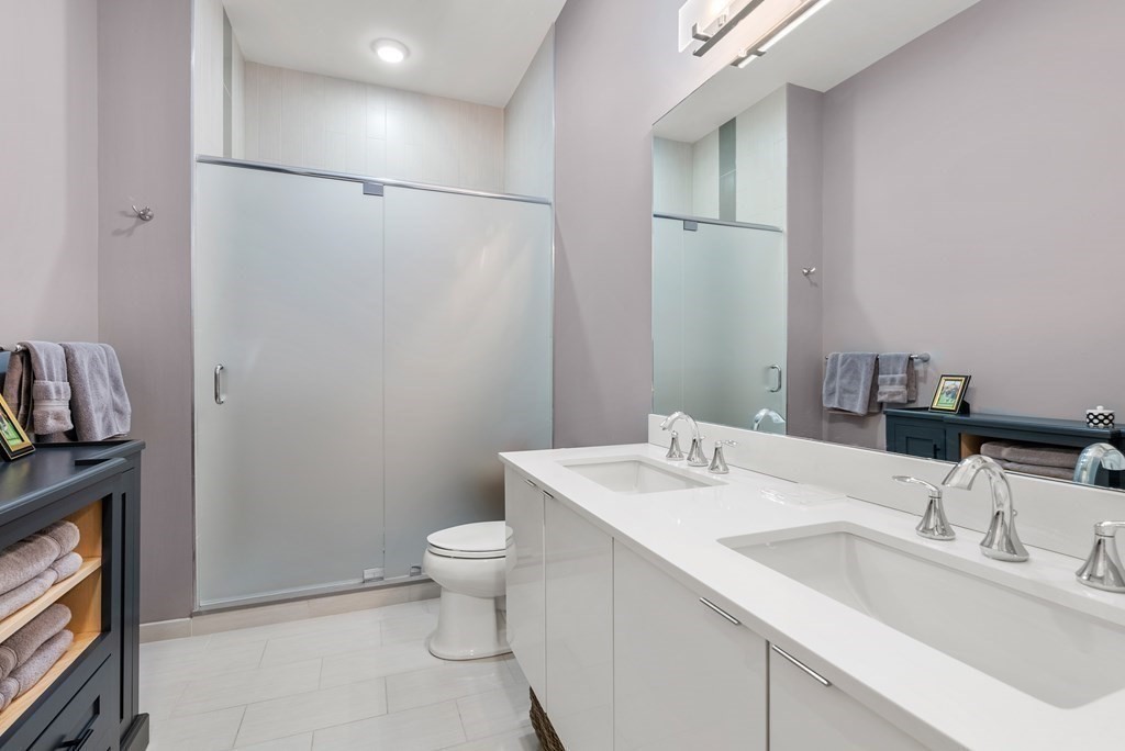 121 Portland Street, Unit 206 Boston, MA 02114 - Photo 18 of 35 a bathroom with a sink toilet and vanity
