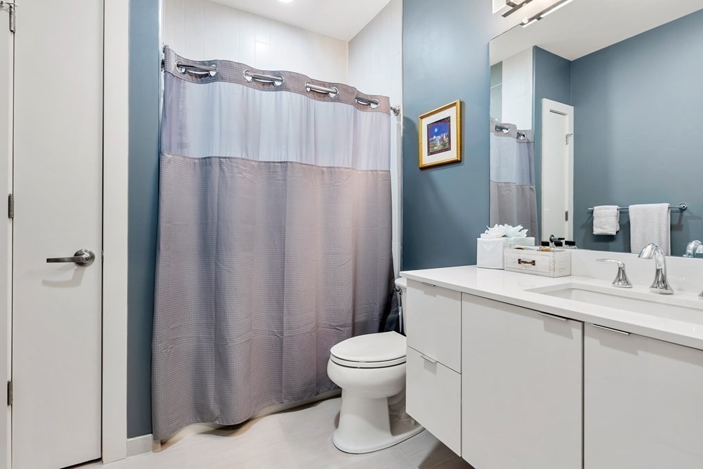 121 Portland Street, Unit 206 Boston, MA 02114 - Photo 23 of 35 a bathroom with a sink a toilet and shower